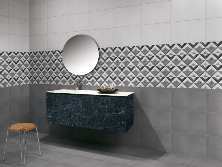 Elegant grey bathroom design featuring a sink, mirror, and cement grey tiles